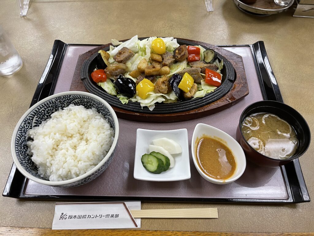 厚木国際カントリー倶楽部のレストランの鉄板焼き定食（ご飯・味噌汁・漬物付き）。悪天候でハーフ終了を見込み、早めのランチで帰路に備える。
